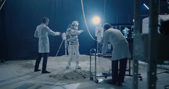 Astronaut and Scientists Testing Spacesuit Mobility alt