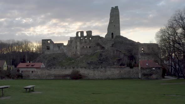 Park with benches below ruins of a Czech medieval castle Okoř,evening.