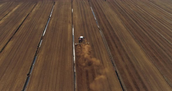 Peat Harvesting Tractor Working in Bog Field Aerial Drone Shot