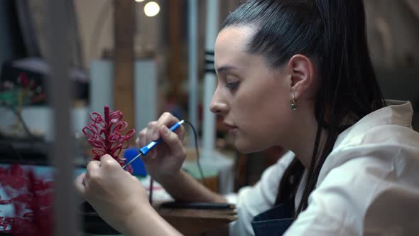 Side View Concentrated Woman Designing Beautiful Decoration in Jewellery Workshop Indoors