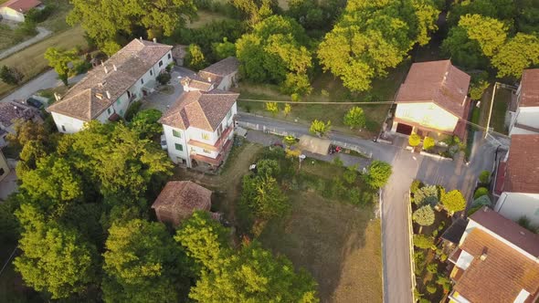 Drone view of some houses during a sunset in the italian countryside