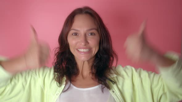 Portrait of Young Woman with Thumbs Up