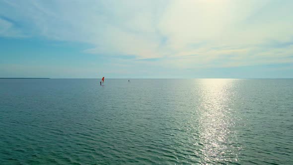 Aerial View Calm Sea Surface and Two Windsurfers