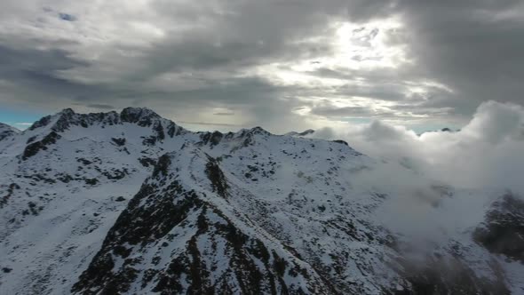 Panorama of Snow-capped Mountains in Clouds