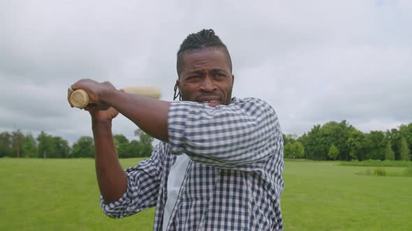 Active African American Man with Baseball Bat Preparing for Pitch