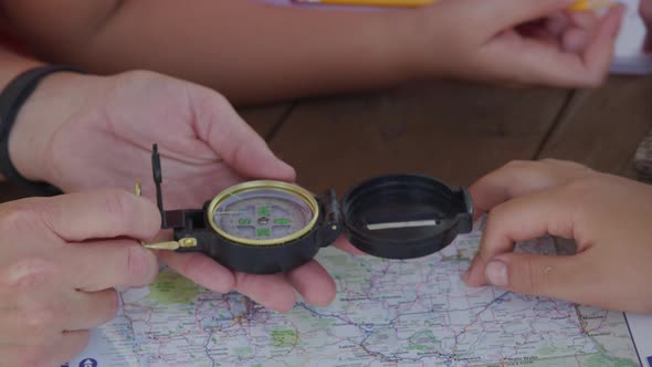 Kids at outdoor school looking at compass