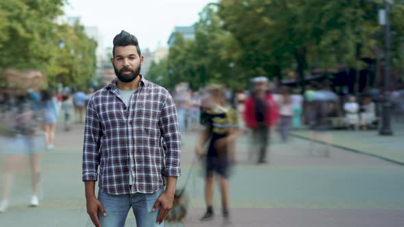 Time Lapse Portrait of Confident Arab Man Standing in Busy Street with Youth Walking Around