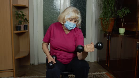 Senior Mature Grandmother Woman in Sportswear Doing Weightlifting Dumbbell Exercising at Home