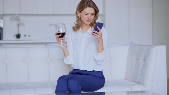 Blonde Female Texting on Mobile in Flat