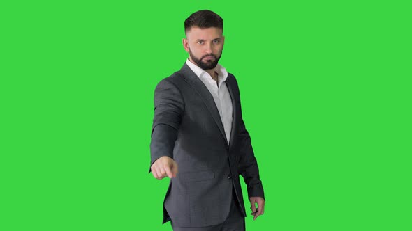 Businessman Pointing Up and Showing Thumbs Up on a Green Screen Chroma Key