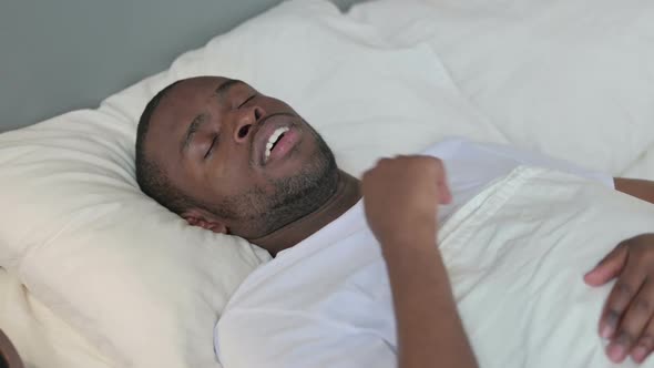 Young African Man with Cough Laying in Bed