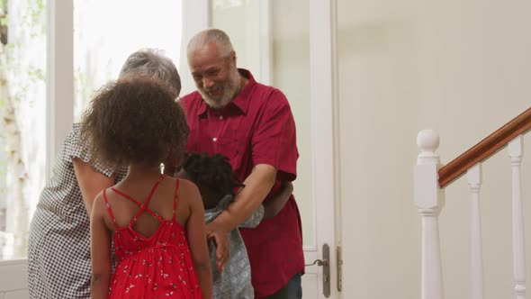 Grandparents embracing their grandson at home