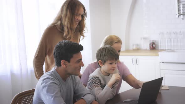 Young Family Using Laptop at Home