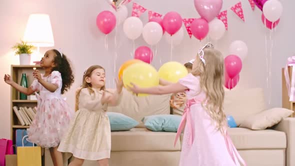 Girls Tossing Balloons in the Air alt