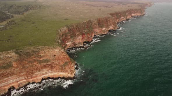 Aerial View of Sea Waves and Fantastic Cliffs Rocky Coast