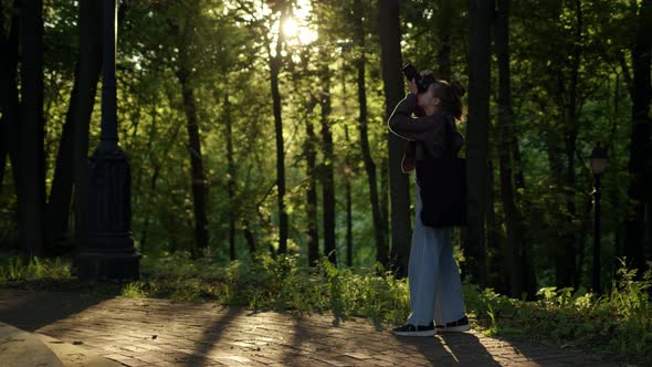 Professional Woman Photographer Take Photo in Forest or Park at Sunset