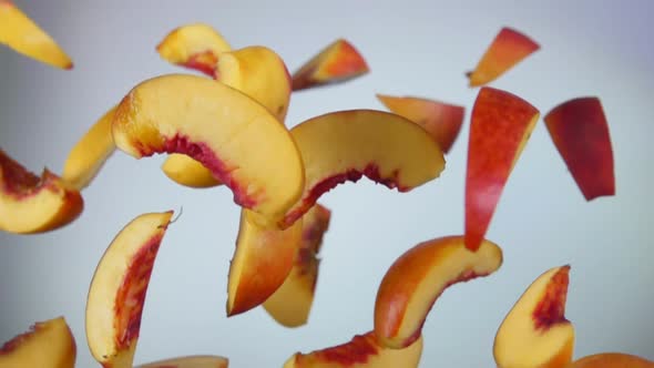 Peach Slices Bounce on a White Background