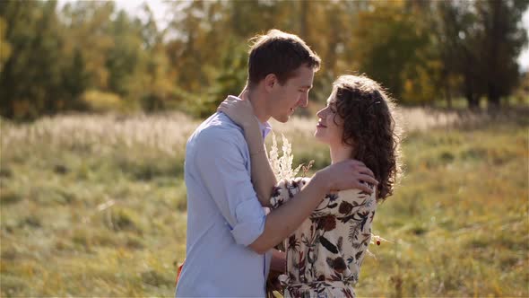 Man Embracing Woman, Hugging and Smiling To Each Other