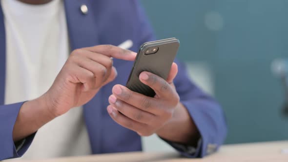 Close Up of Hands of African Businessman Using Smartphone