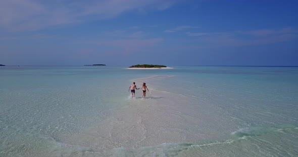 Romantic couple married on vacation live the dream on beach on white sand background 