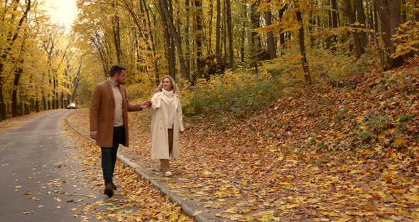 Young Couple in Beige Clothes in the Autumn Park