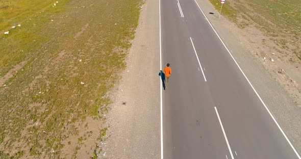 Low Altitude Flight Over Sporty Man at New Asphalt Road