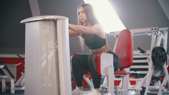 An Athlete Woman Training in the Gym - Exercising on the Butterfly Training Apparatus