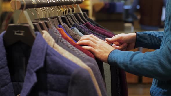 Man Choosing Wear at Clothing Store