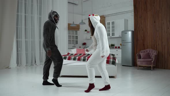 Positive Couple in Pajamas Performing Moonwalk