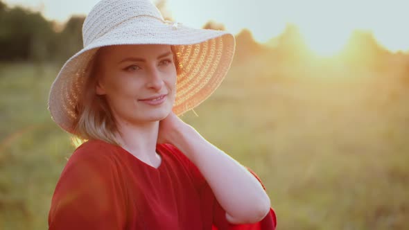 Portrait of Positive Smiling Woman Looking Into Camera at Sunset