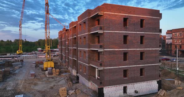 Construction site of low-rise brick houses in summer. Aerial view