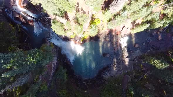 Aerial Flying Down Into Gorge with Secret Blue Waterfall