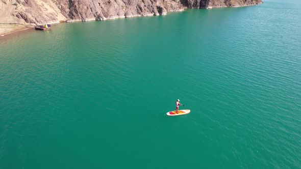 A Guy Goes Sup Surfing in a Lake Near the Shore