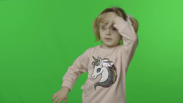 Positive Girl in Unicorn Sweatshirt Waving Her Hands