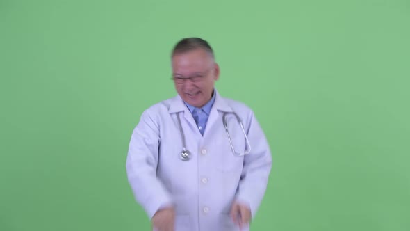 Happy Mature Japanese Man Doctor Dancing