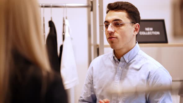 Positive male receptionist talking to saleswoman