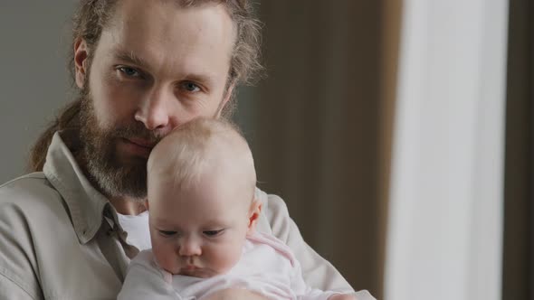 Family Portrait Serious Caucasian Bearded Dad Father Man Holding Hugging Small Infant Newborn Girl