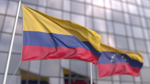 Flags of Colombia and Venezuela in Front of a Skyscraper