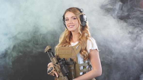 Female Private Military Contractor Dressed in Tactical Uniform Armed with Riffle, Slow Motion