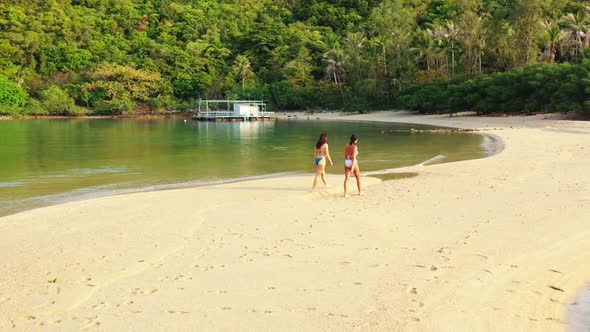 Tourists relaxing on tropical seashore beach adventure by clear sea with white sand background of Th