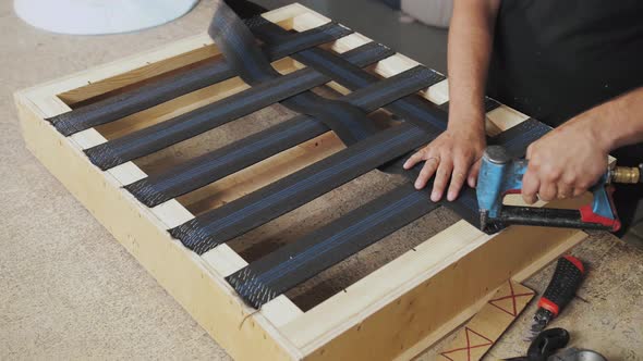 A Worker Makes a Sofa in a Furniture Factory