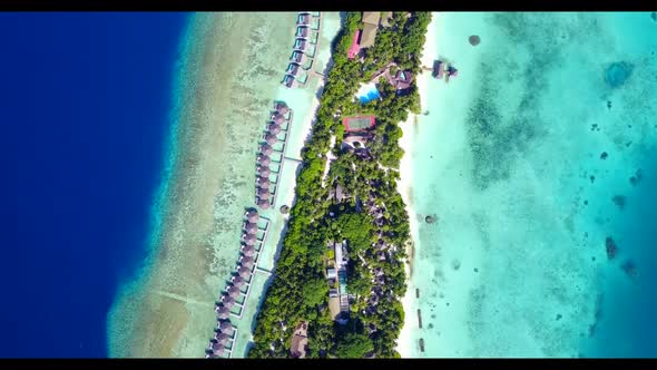 Aerial drone view travel of tranquil shore beach holiday by blue green sea with clean sandy backgrou