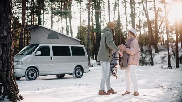 Romantic Couple Resting in the Woods on Sunny Winter Day Enjoying Van Life