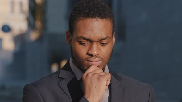 Pensive Black Millennial Student Considering Choice Makes Difficult Decision Outdoors Serious