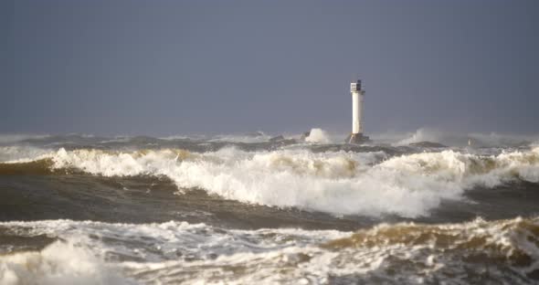 4K - Atlantic storm. Huge waves crash into lighthouse