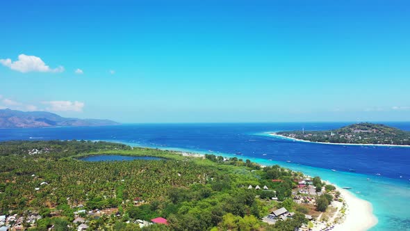 Wide angle aerial tourism shot of a sunshine white sandy paradise beach and aqua turquoise water bac