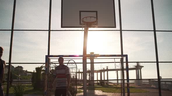 Young Active People Playing Streetball on Beautiful Outdoor Sports Ground