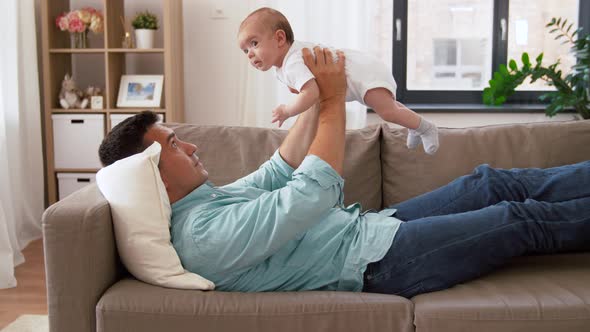 Middle Aged Father with Baby Daughter at Home