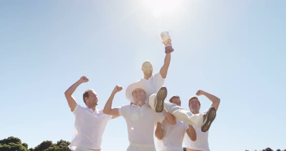 Cricket team with trophy on cricket field