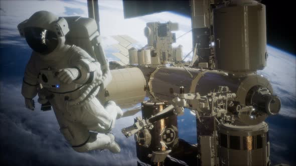 International Space Station and Astronaut in Outer Space Over the Planet Earth alt